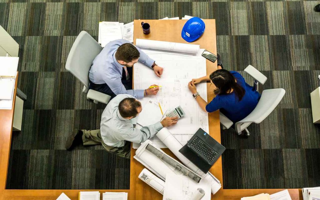 Meeting between architects with blueprints
